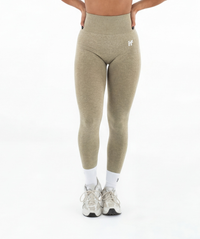 Green leggings worn by a person on a white background