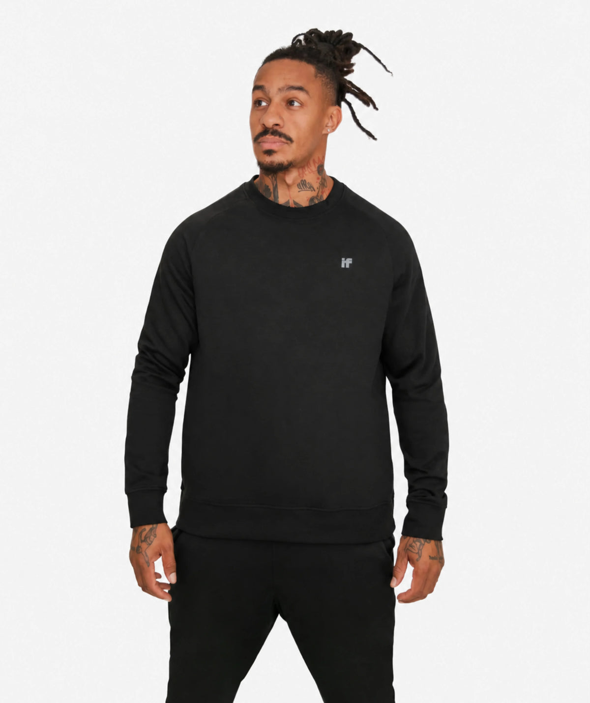 A man modeling a black crewneck sweatshirt with a small white 'IF' logo on the left chest, paired with black pants, against a plain white studio background.