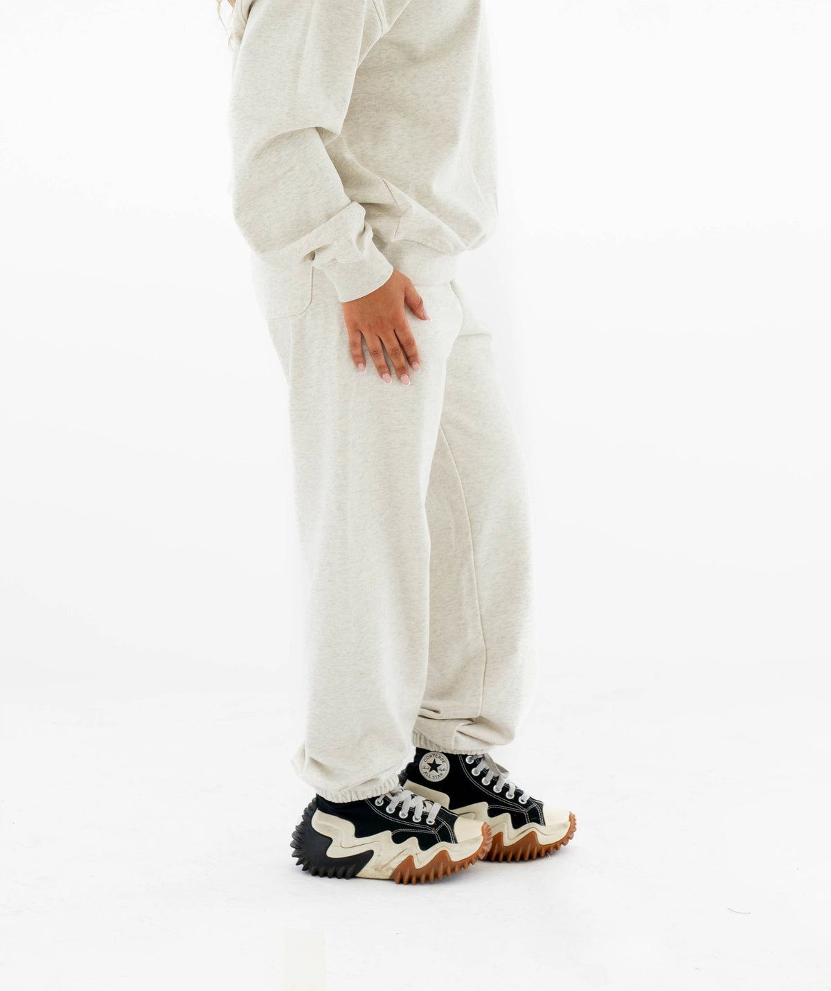 light gray outfit with black and white sneakers