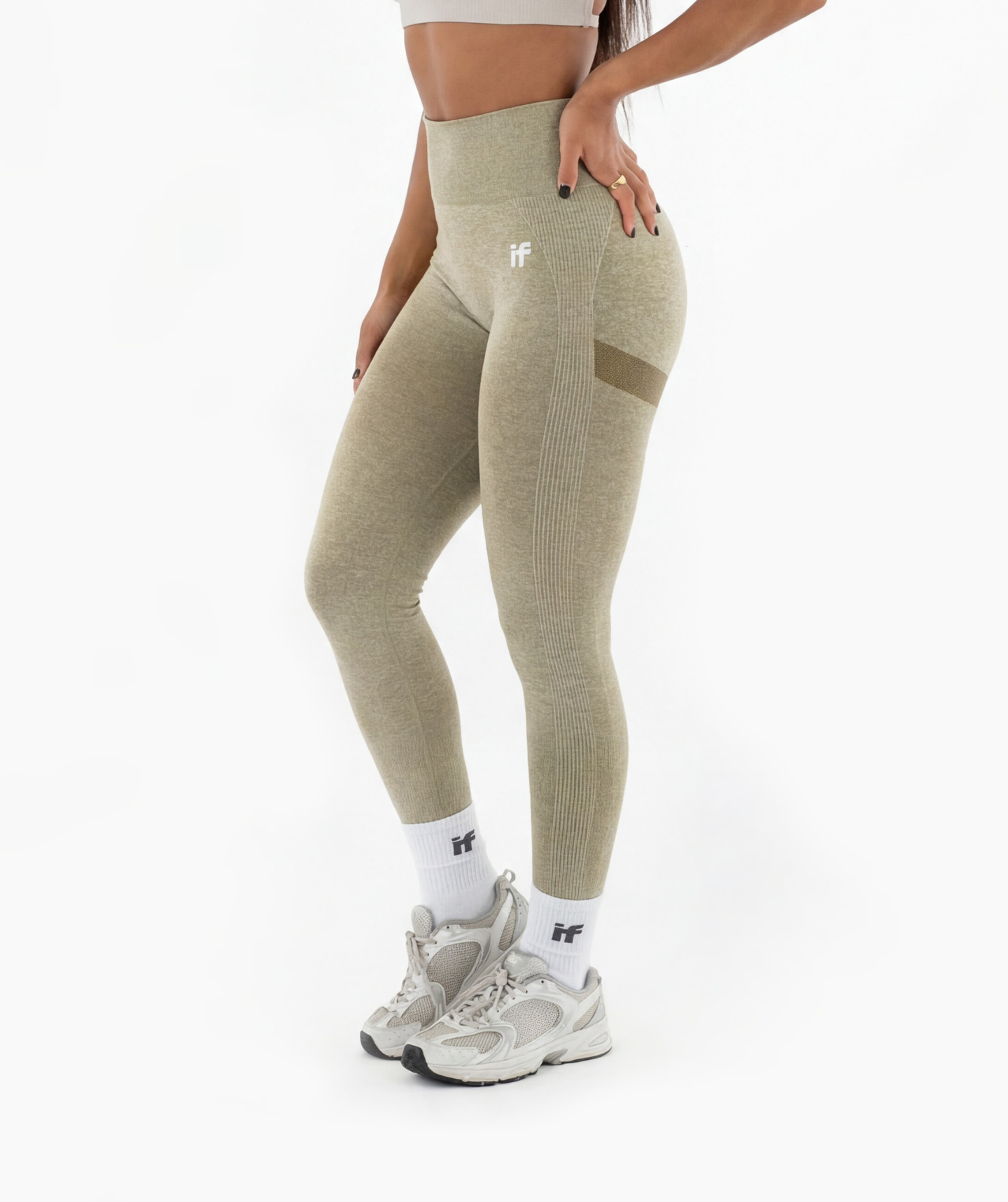 Person wearing marl green leggings with a brand logo on a white background